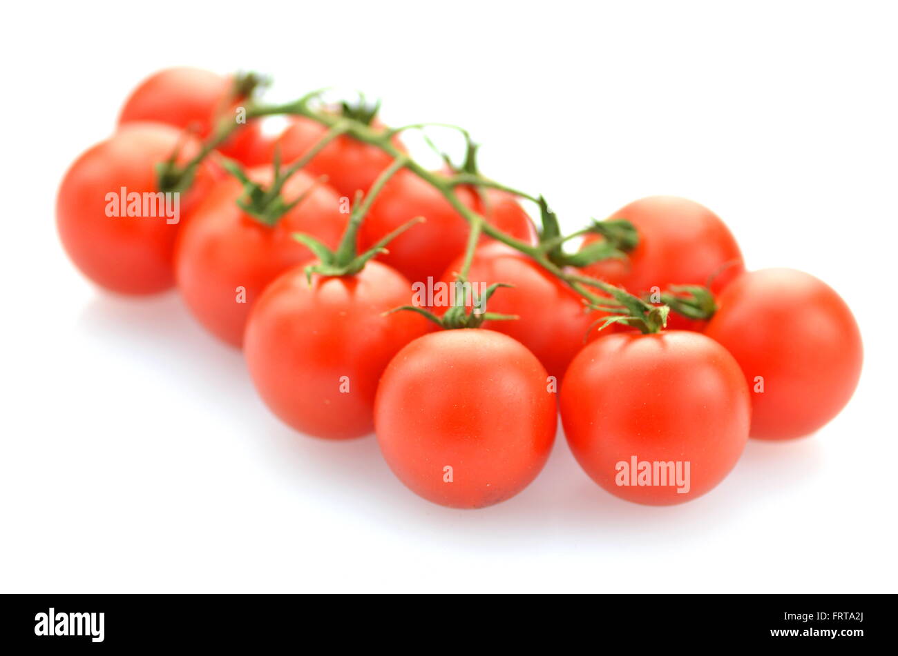 branch of fresh cherry tomatoes isolated on white background Stock ...