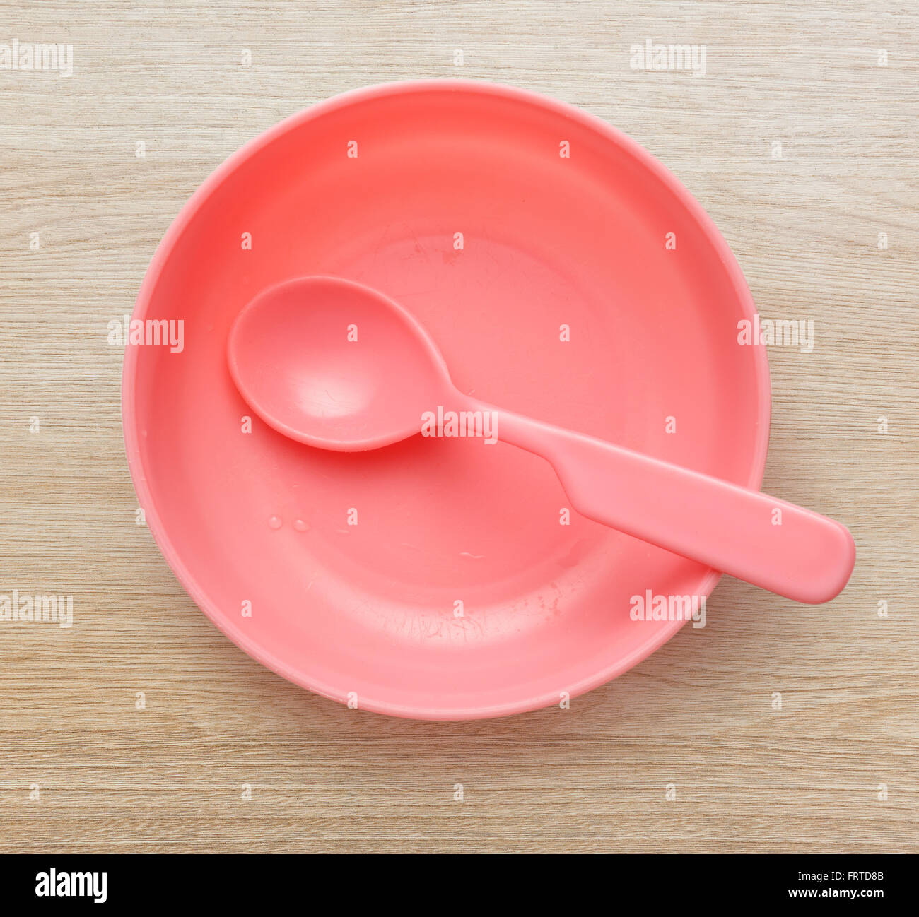 Pink plastic tableware dish, spoon and fork Stock Photo Alamy