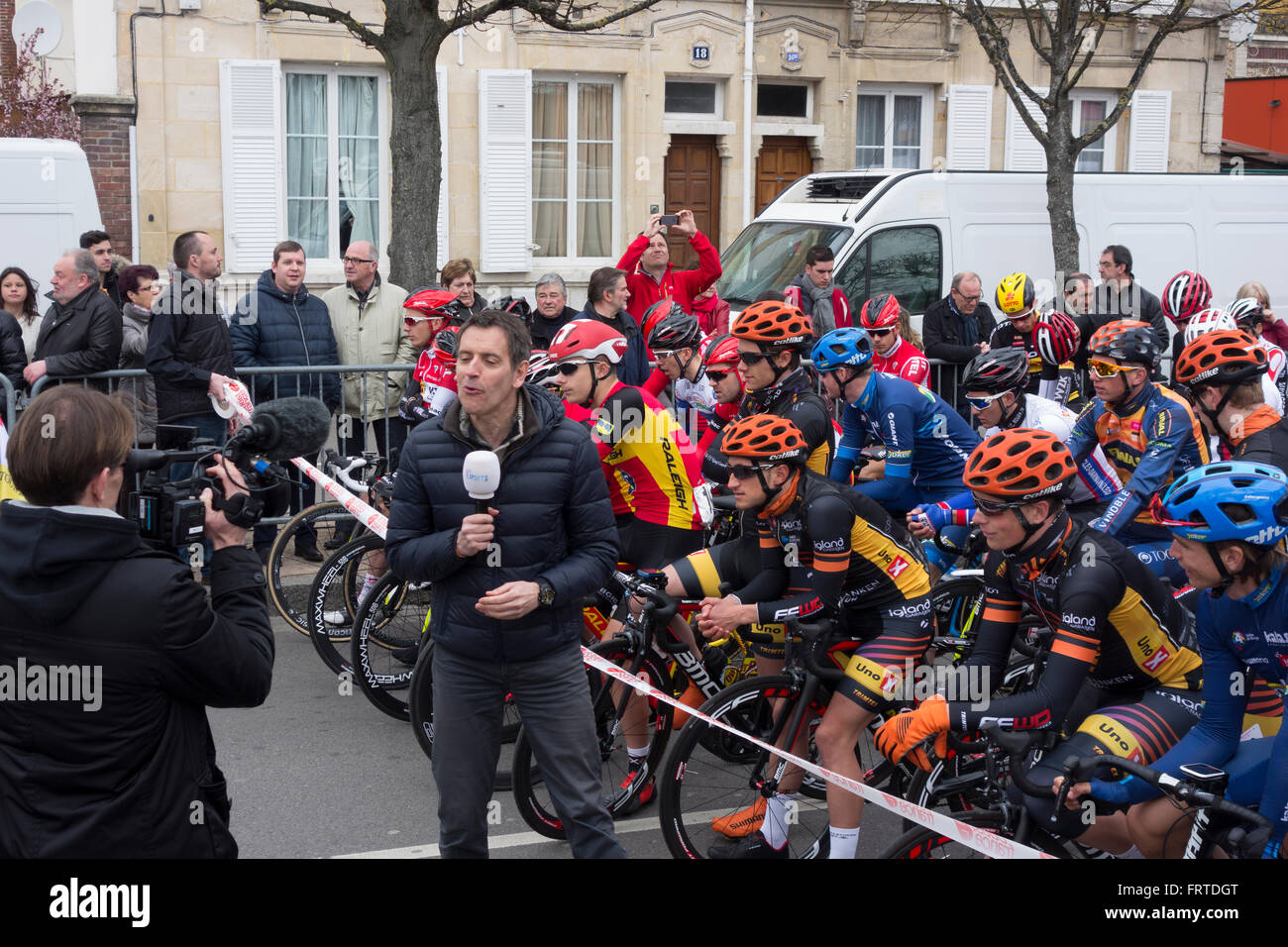 TV sports presenter and cyclists at the start of the second stage of Tour de Normandie, Vernon, France Stock Photo
