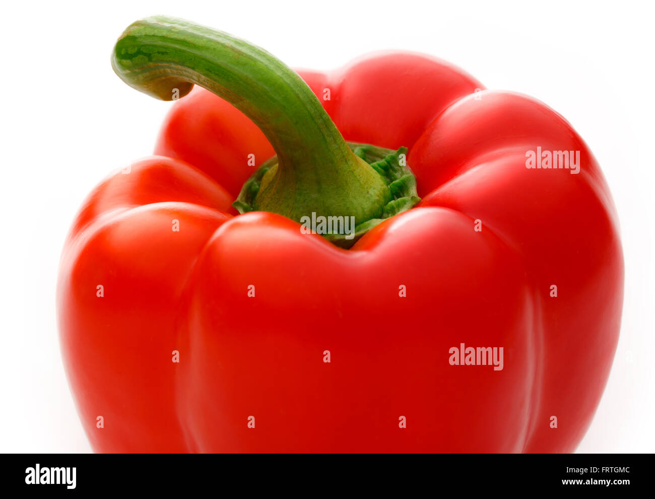 Single red paprika on the white background Stock Photo