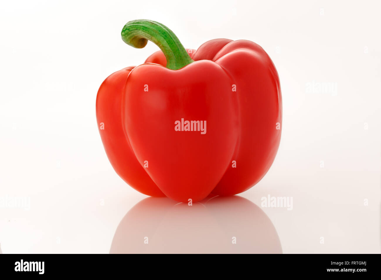 Single red paprika on the white background Stock Photo