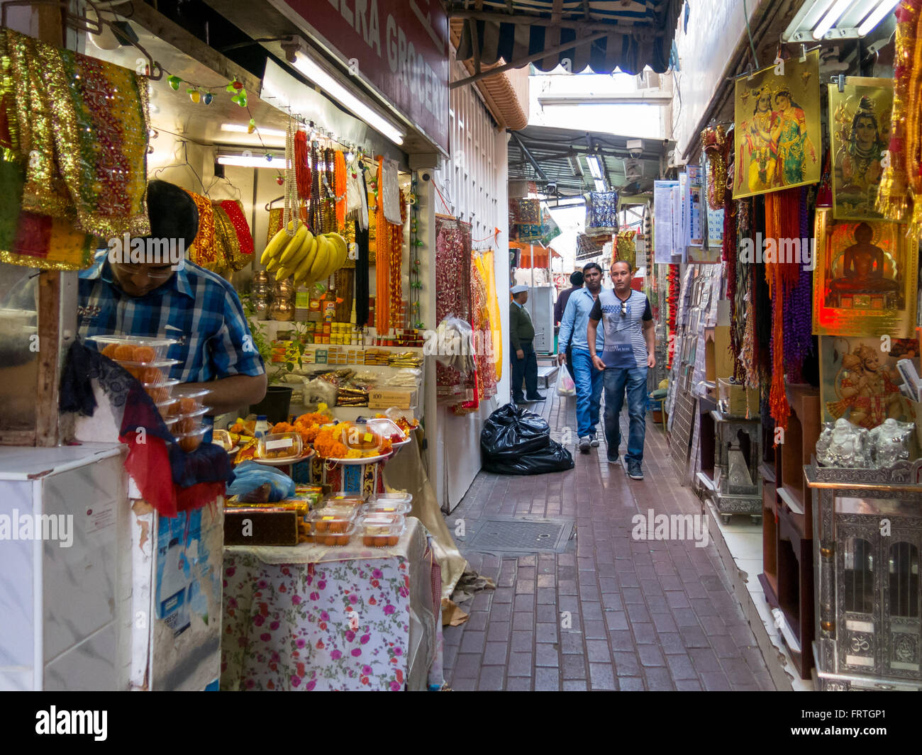One of the narrow streets in the ancient covered textile souq Bur Dubai in the old city centre of Dubai, United Arab Emirates Stock Photo