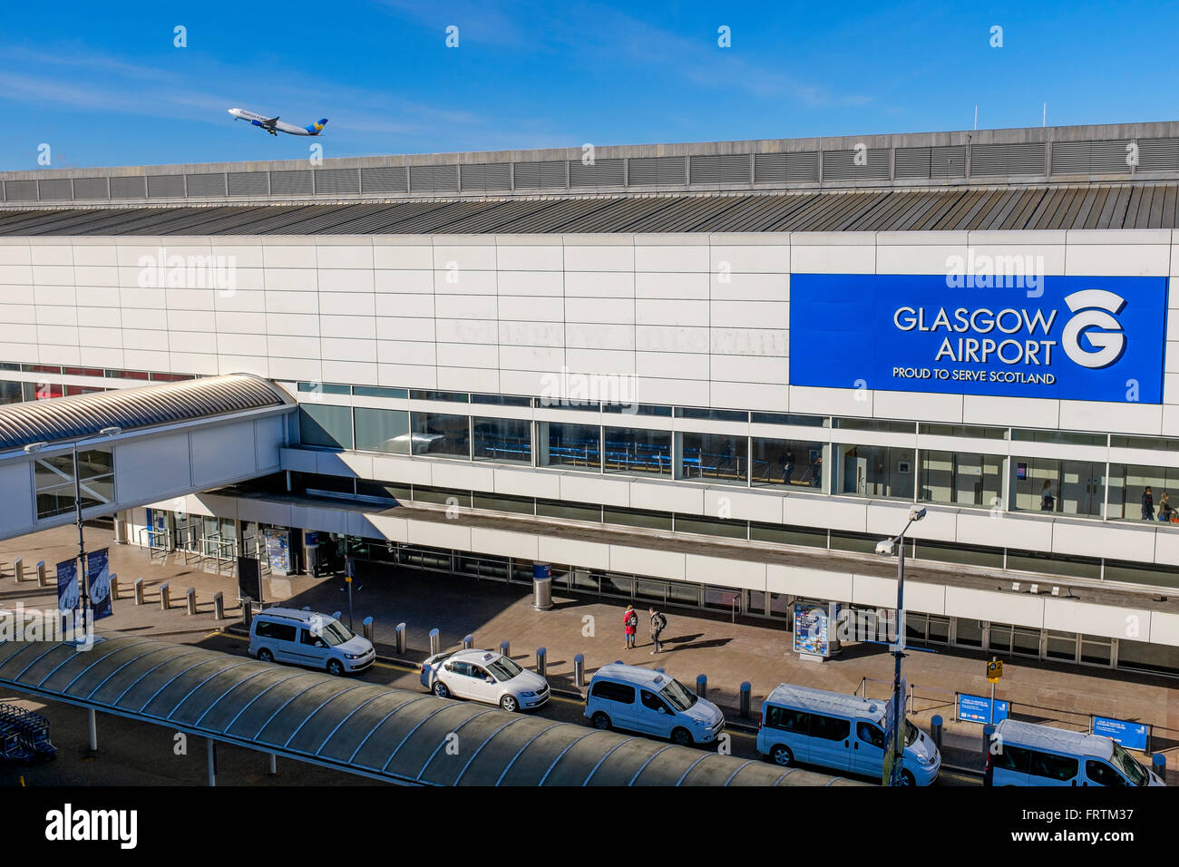 Terminal building of Glasgow Airport, Scotland, UK with taxi rank and planes in the background Stock Photo