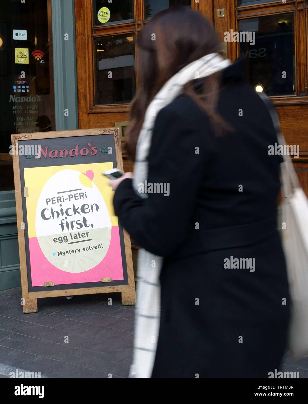 Easter promotion poster outside of Nando's fast food outlet in Islington, London Stock Photo