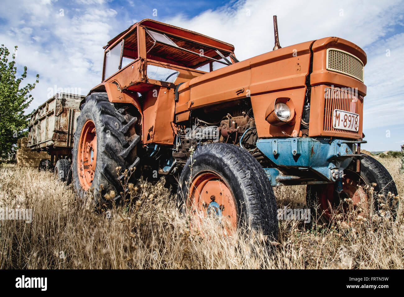 old agricultural tractor abandoned in a farm field Stock Photo - Alamy