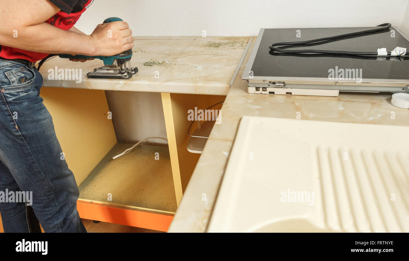 Installing new induction hob in modern kitchen Stock Photo Alamy