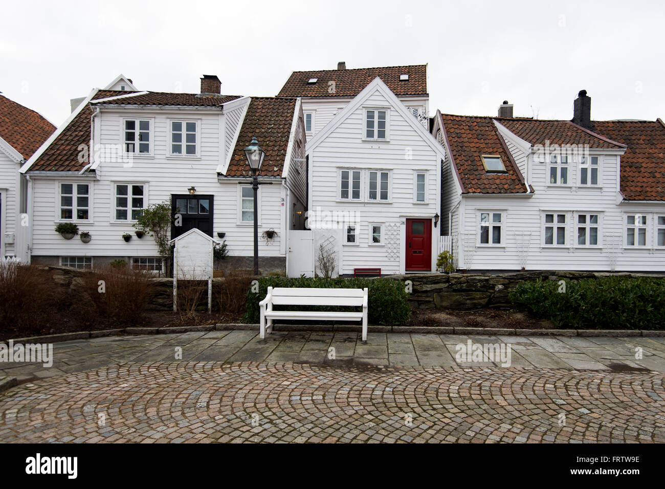 Old white wooden houses on cobbled streets in the old town in Stavanger, Norway. Stock Photo