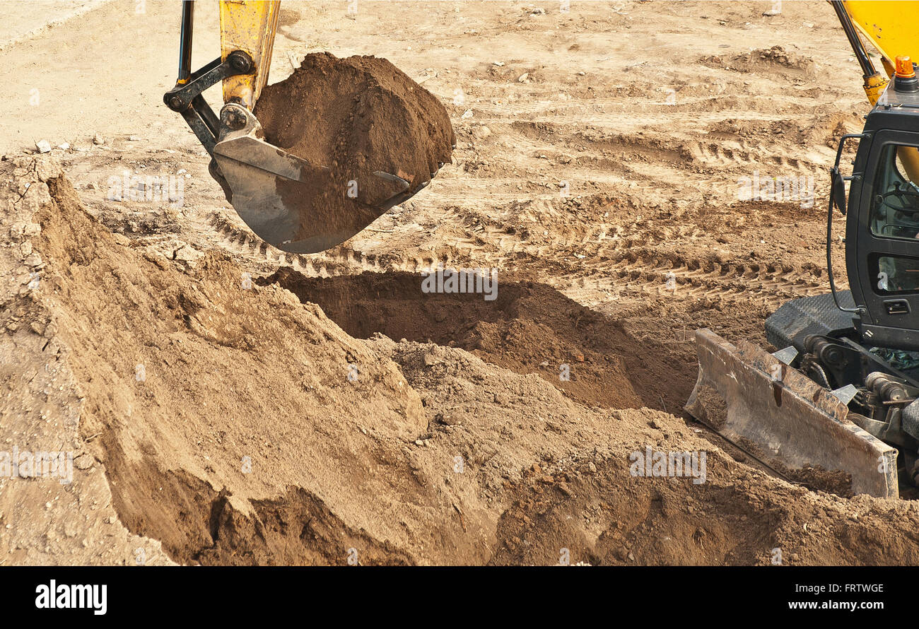 excavator works in sand mine Stock Photo