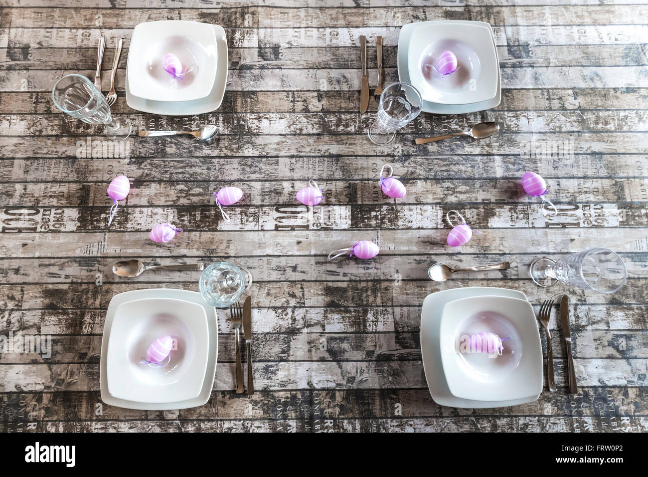 Four place settings on laid table with Easter decoration Stock Photo