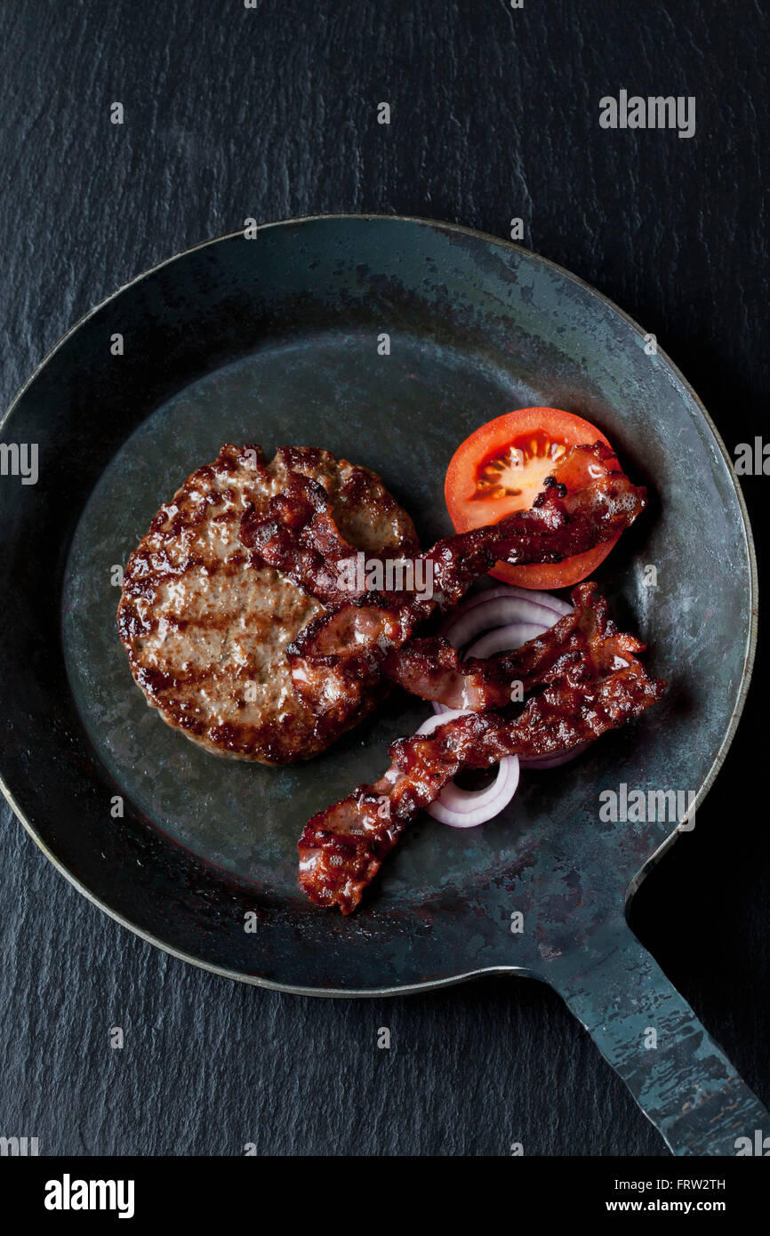 Fried beef patties with bacon in pan Stock Photo Alamy
