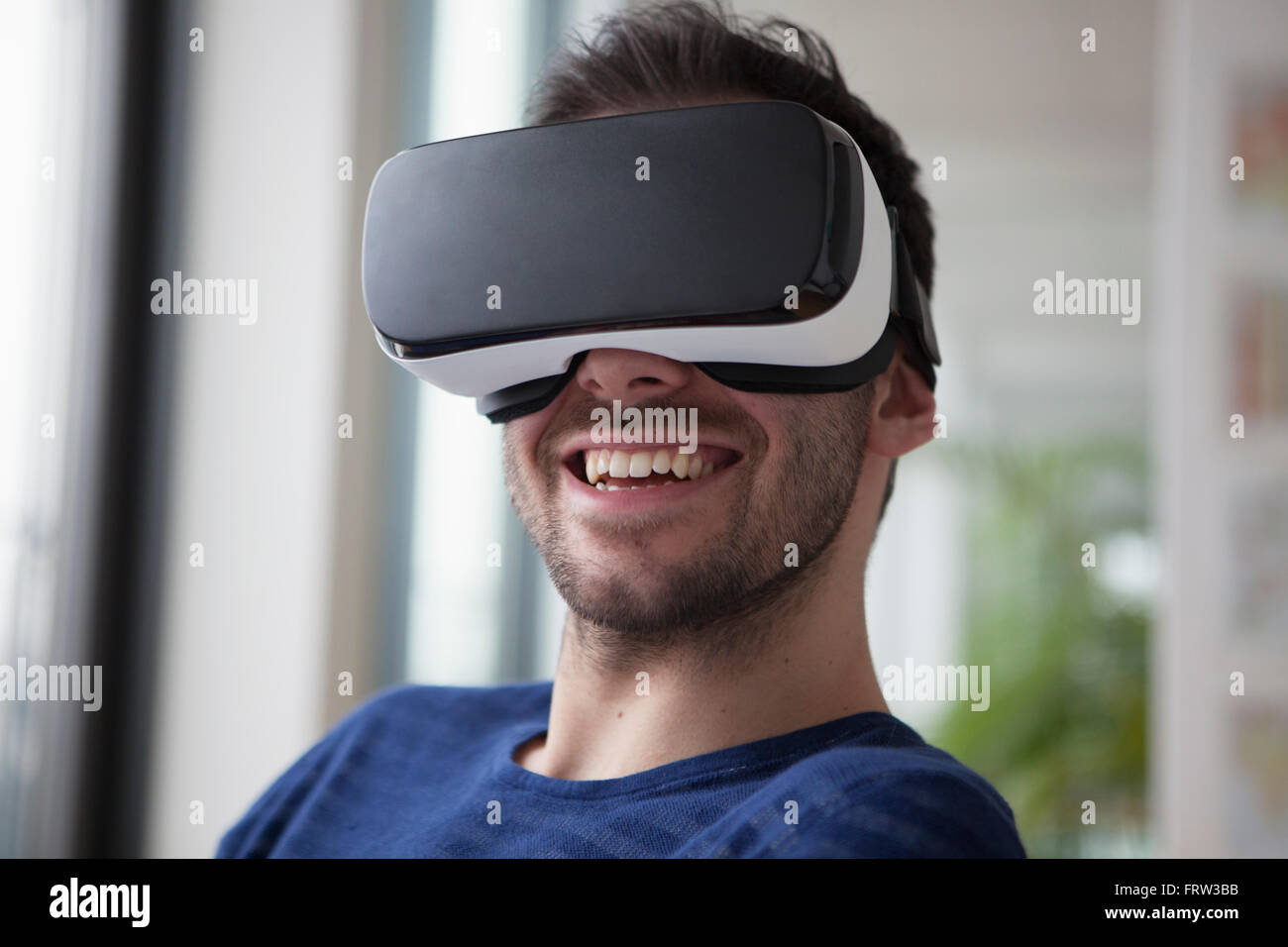 Smiling man wearing Virtual Reality Glasses Stock Photo - Alamy