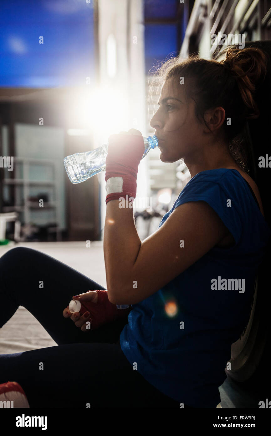Female boxer taking a rest and drinking water Stock Photo - Alamy