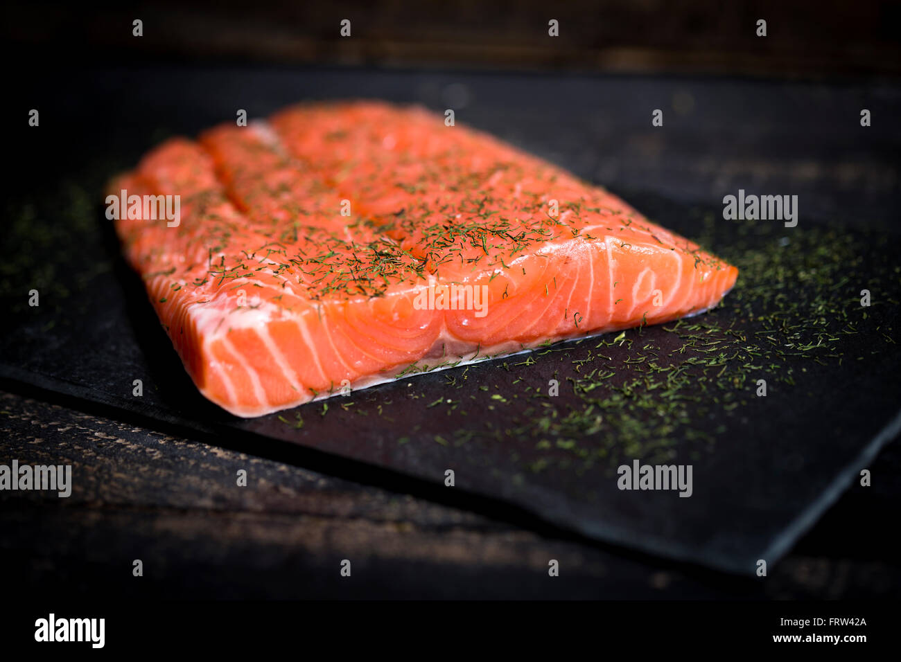 Raw salmon fillet on black slate Stock Photo - Alamy
