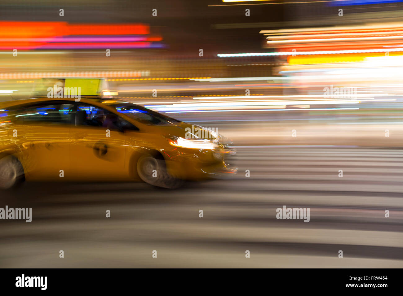 Blurry abstract photo of yellow taxi cabs in motion in Manhattan, New York City Stock Photo