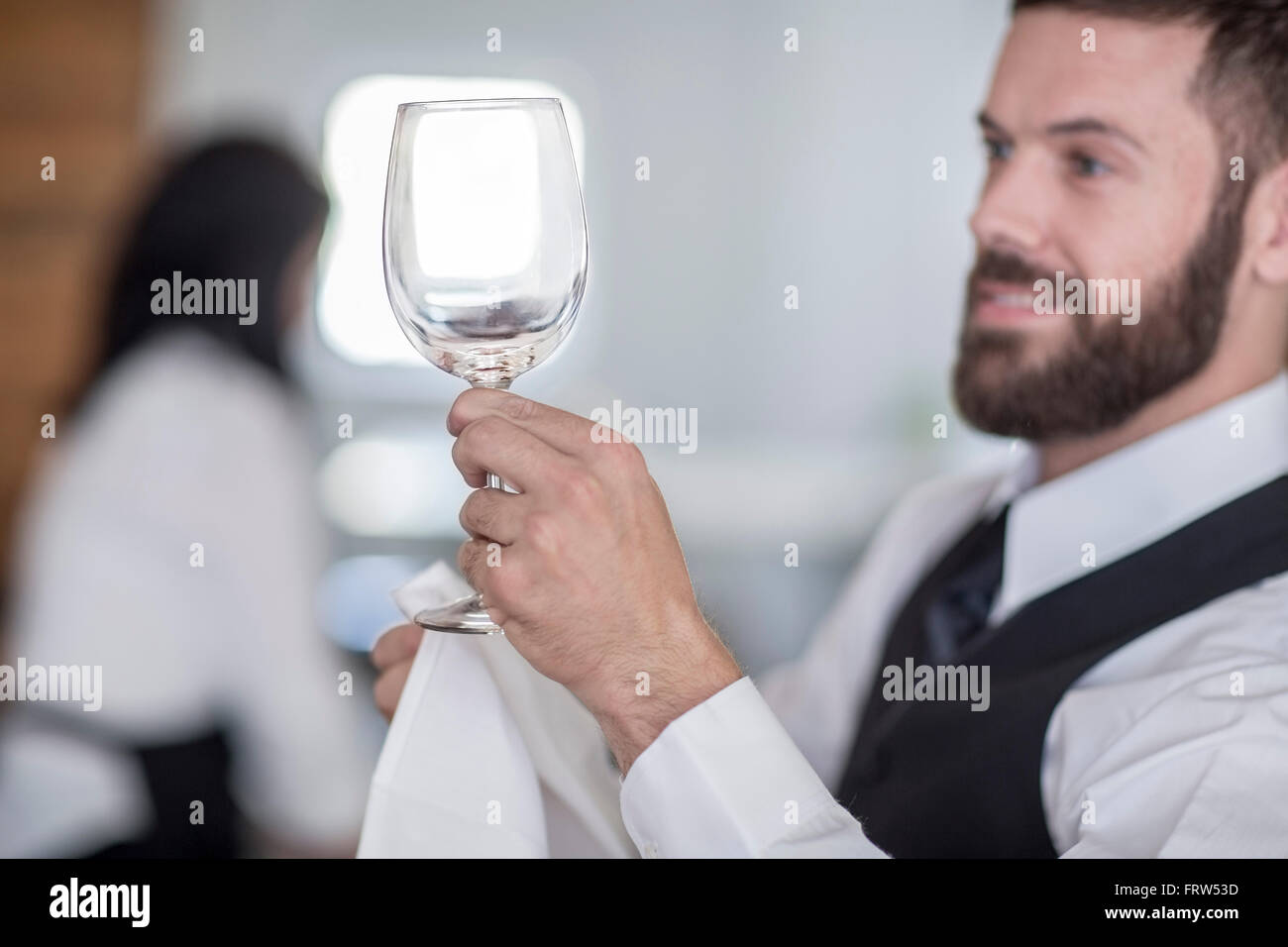 Waiter polishing wine glasses in restaurant Stock Photo Alamy
