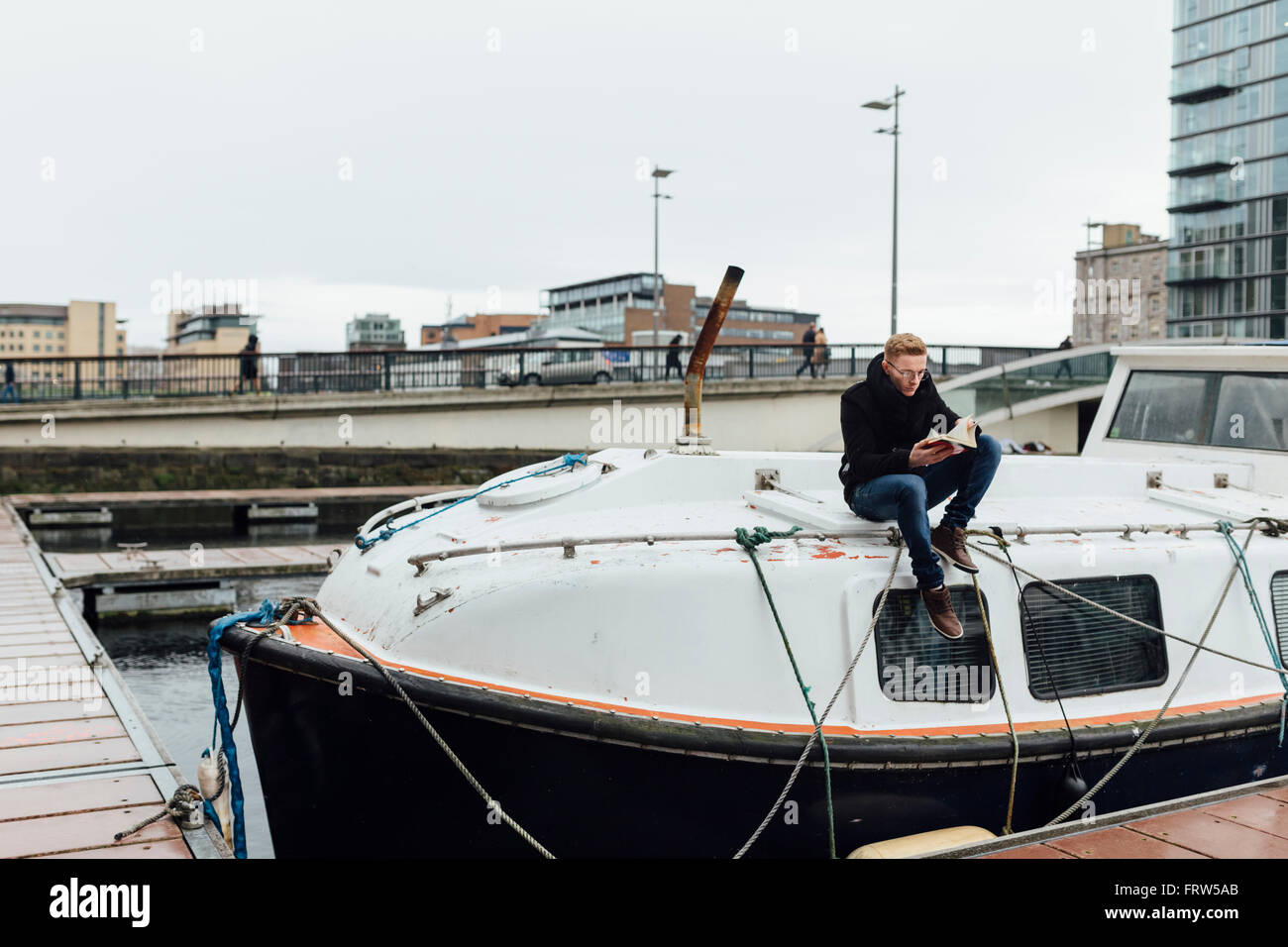 Young man sitting on motorboat hi-res stock photography and images - Alamy