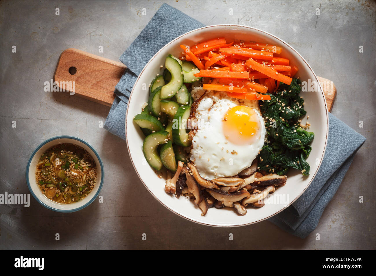 Vegetarian korean rice bowl with mushroom, spinach, cucumber, carrot