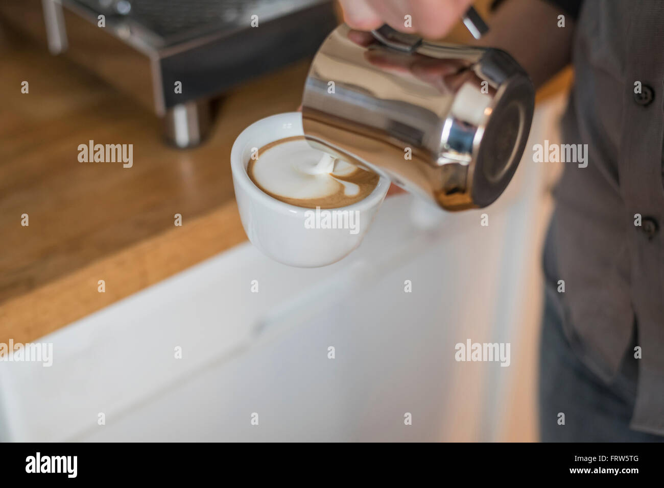 Cappuccino, pouring milk froth in cup Stock Photo Alamy