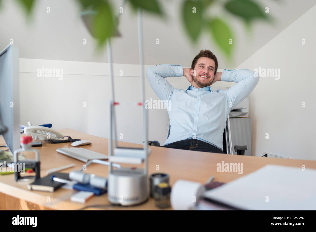 Young professional leaning back hi-res stock photography and images - Alamy