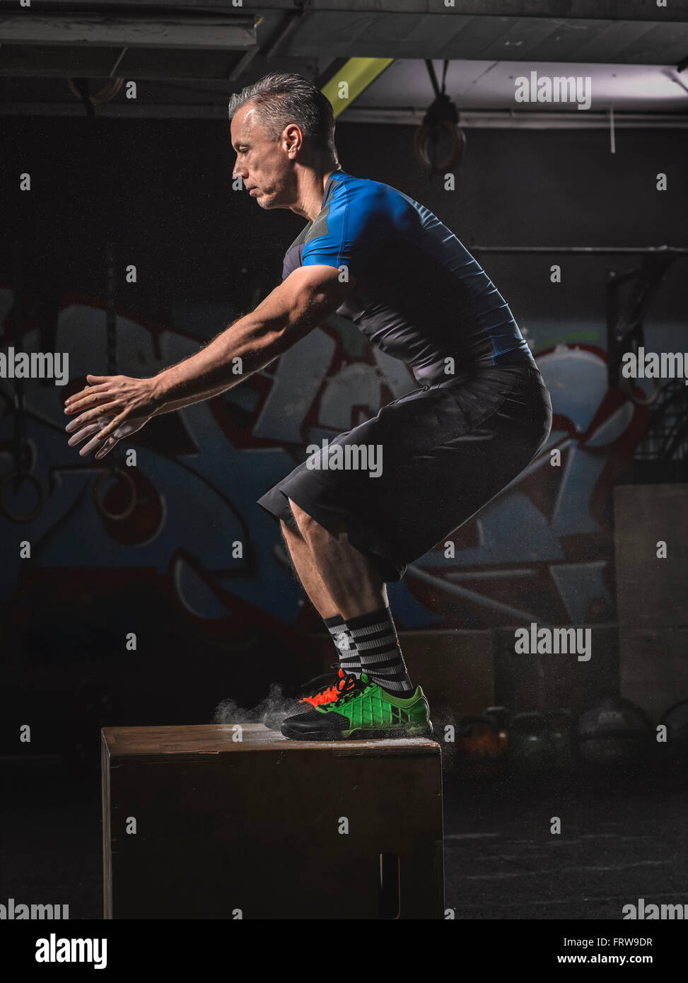 Mature crossfit athlete doing a box jump Stock Photo