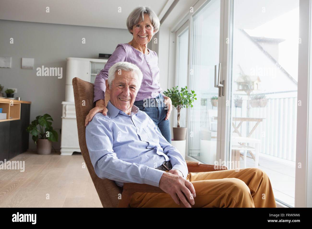 Portrait of relaxed senior couple at home Stock Photo - Alamy