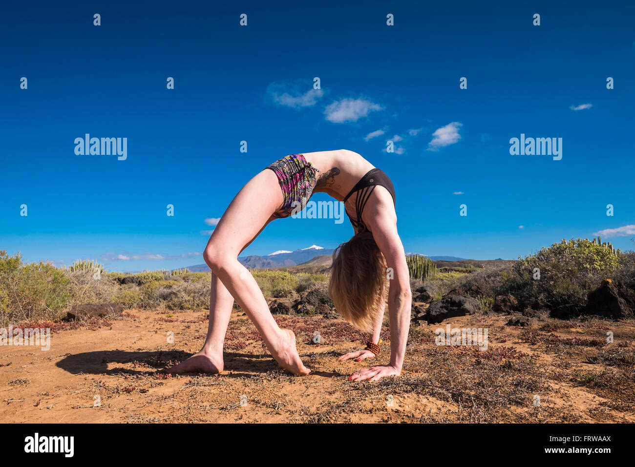 Spain, Tenerife, young woman doing bridge position Stock Photo