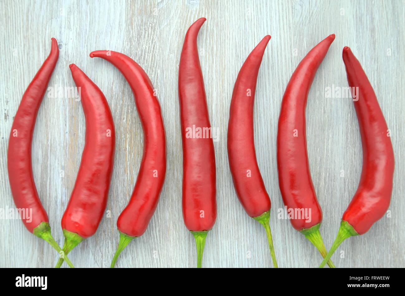 red hot chilli peppers on table Stock Photo - Alamy