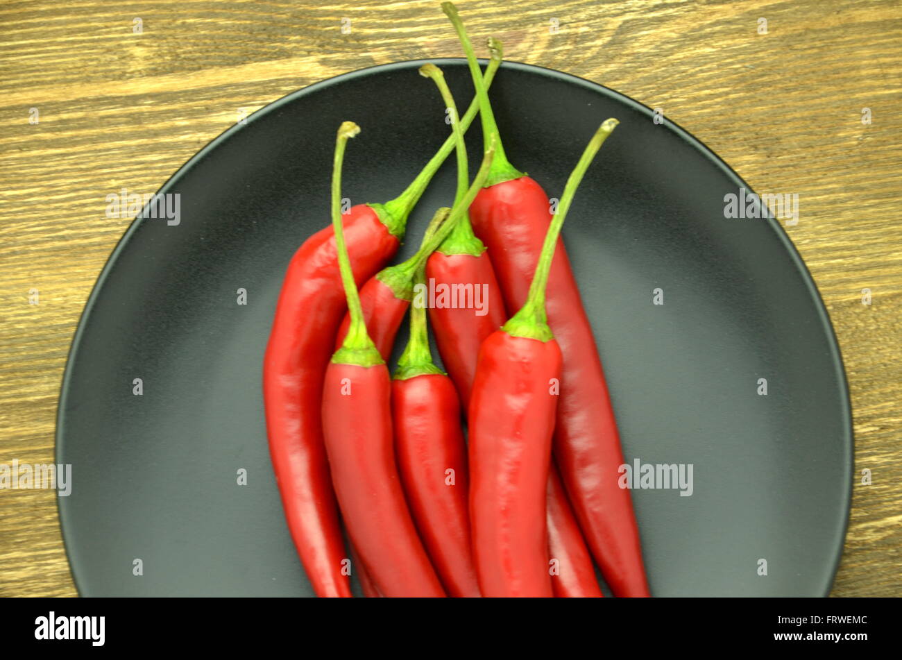 red hot chilli peppers on table Stock Photo - Alamy