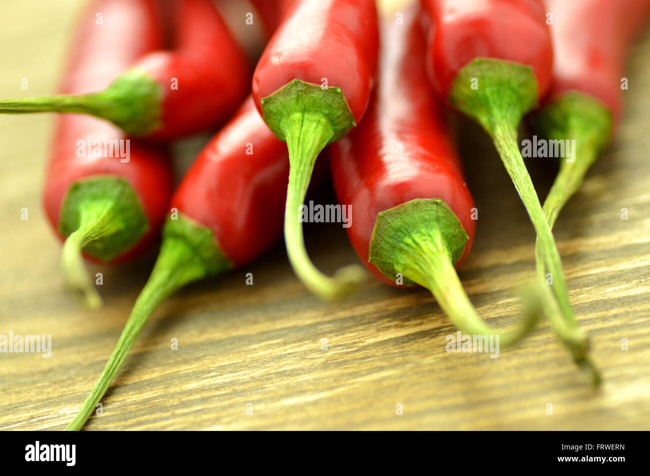 red hot chilli peppers on table Stock Photo - Alamy