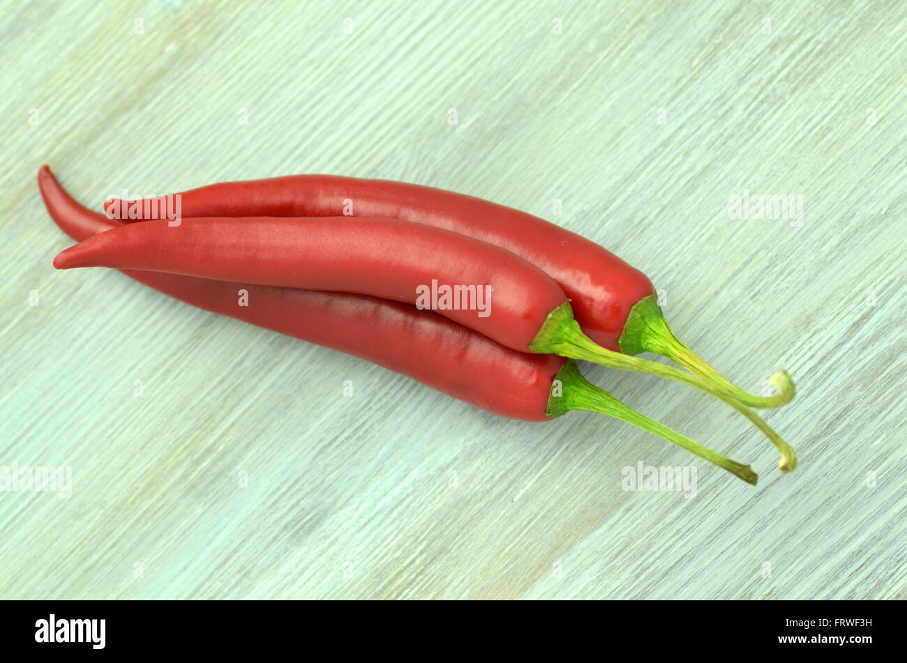 red hot chilli peppers on table Stock Photo - Alamy