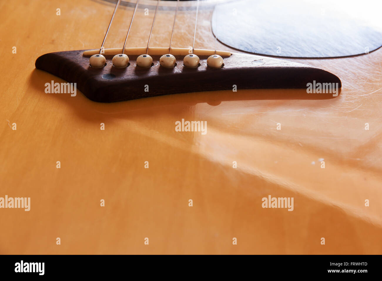 bridge acoustic guitars. six strings for background Stock Photo Alamy