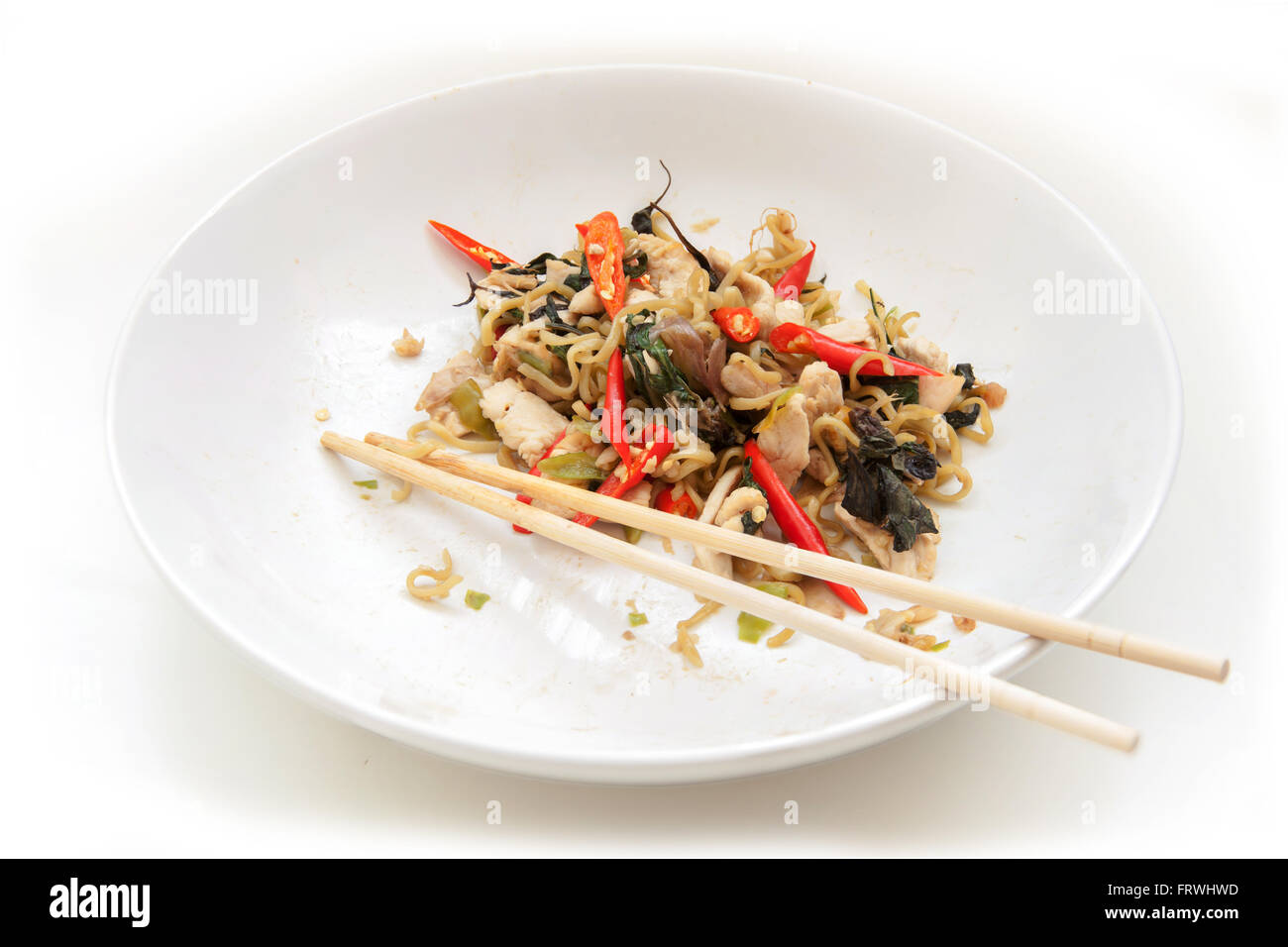 Chinese noodles fried with spicy chicken in white plate. with clipping paths. Stock Photo