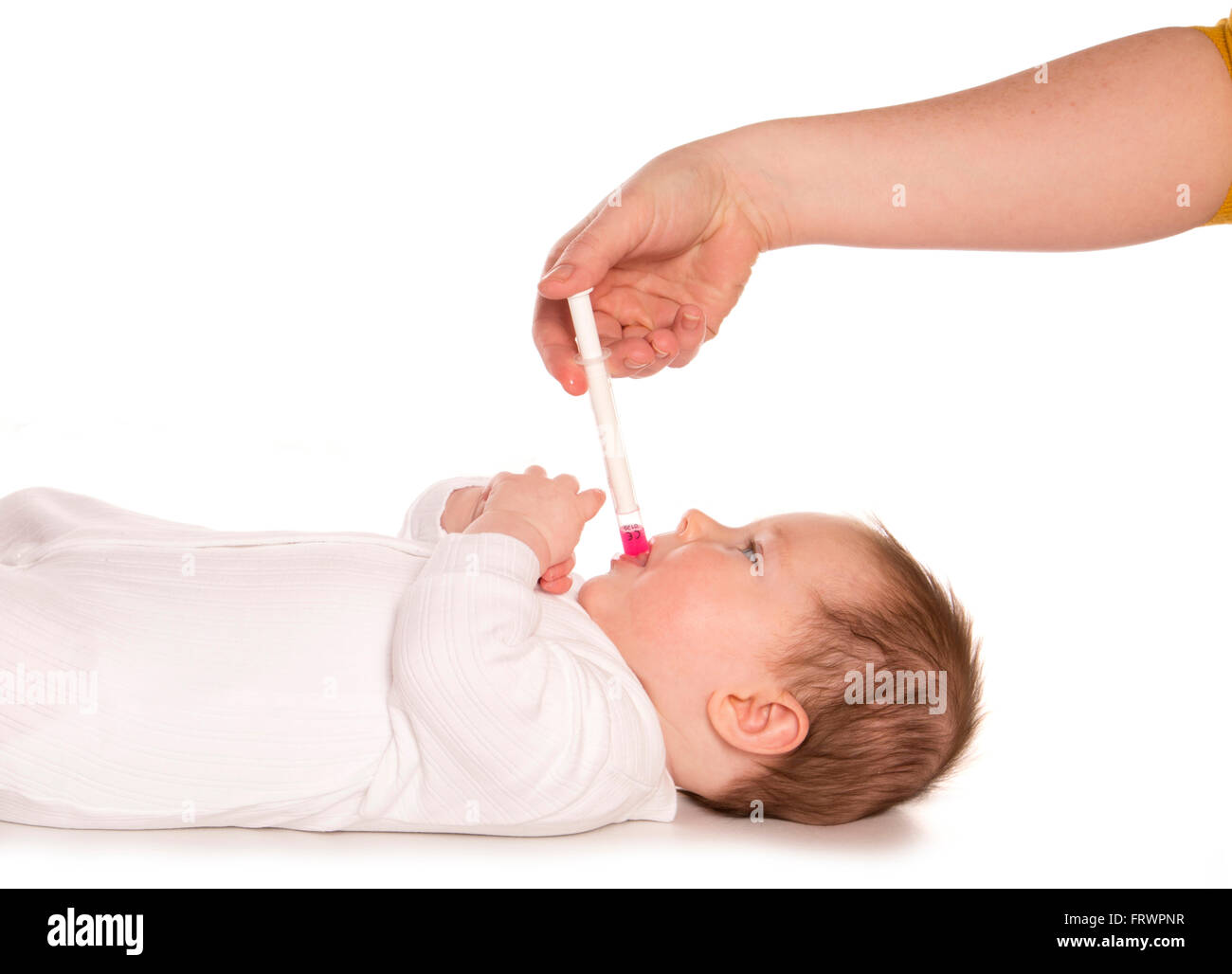parent giving baby calpol for teething cutout Stock Photo