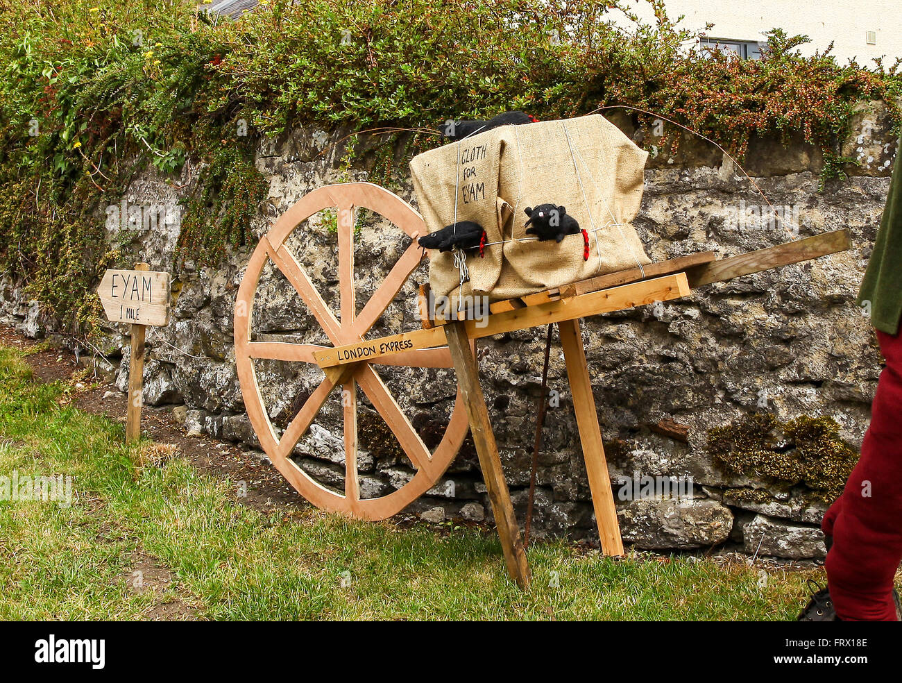 A wheel barrow with rats signifying the contaminated cloth that brought the plague or black death to Eyam Derbyshire England Stock Photo