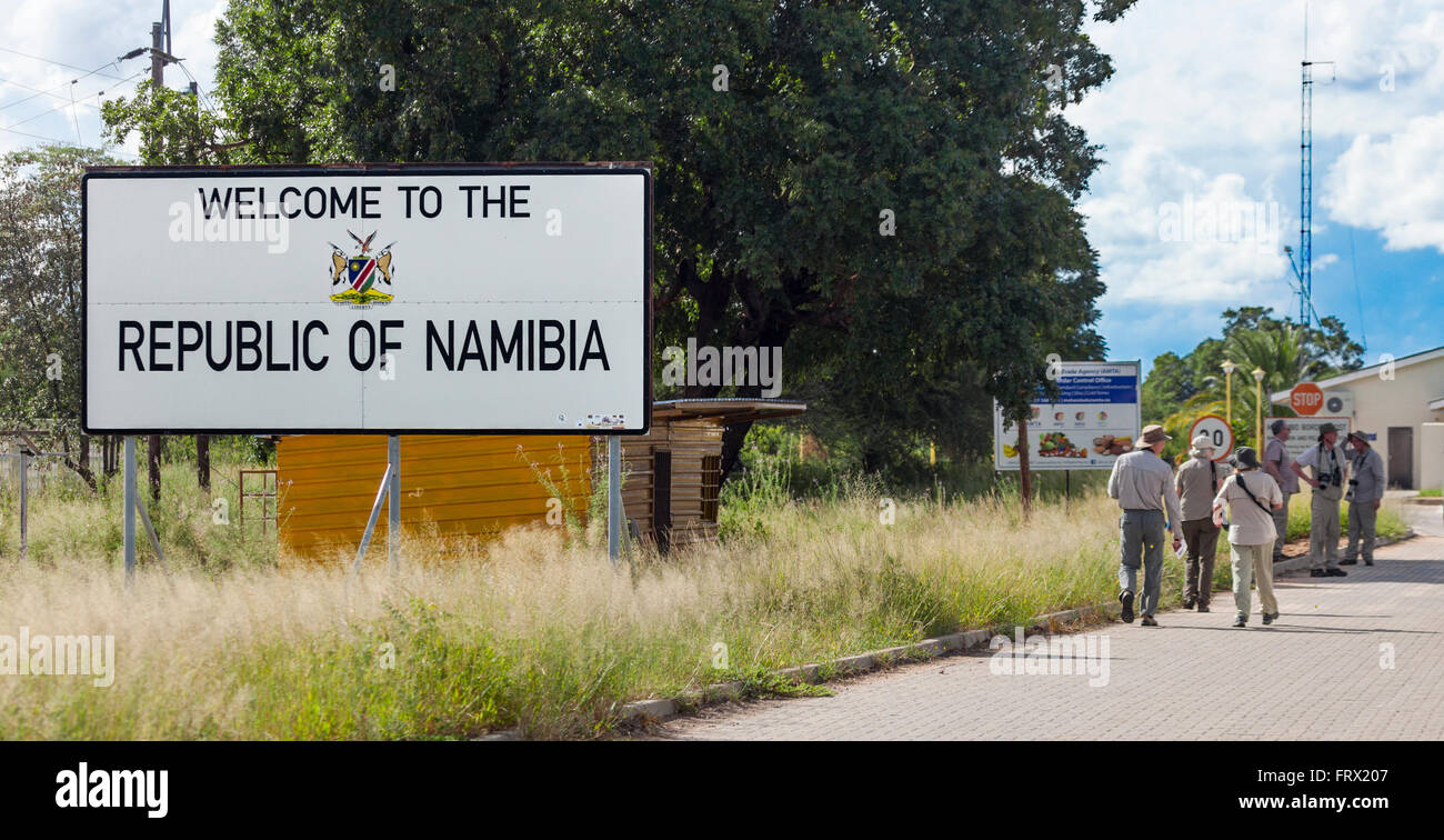 Safari eco-tourists passing the Welcome to Namibia sign at the Muhembo border post with Botswana, southern Africa Stock Photo