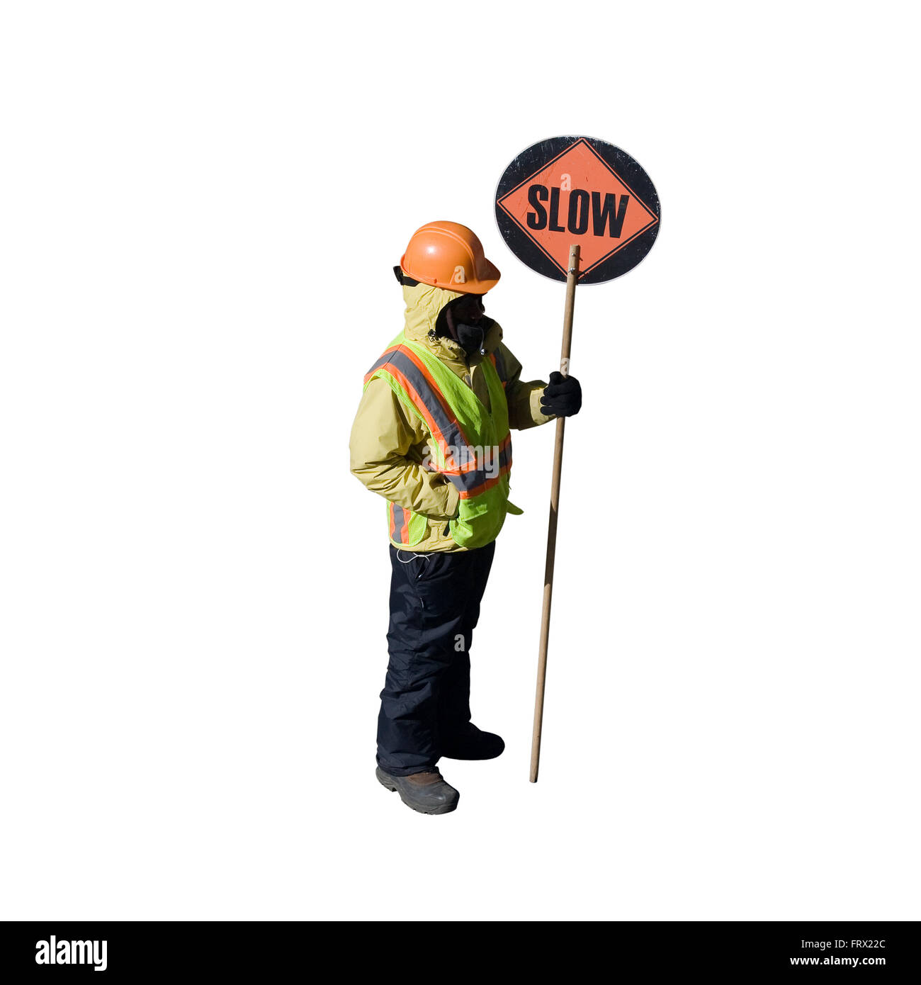 Cut Out Construction Worker with a hardhat and an orange reflective vest holds a round sign on a pole with SLOW printed on it Stock Photo