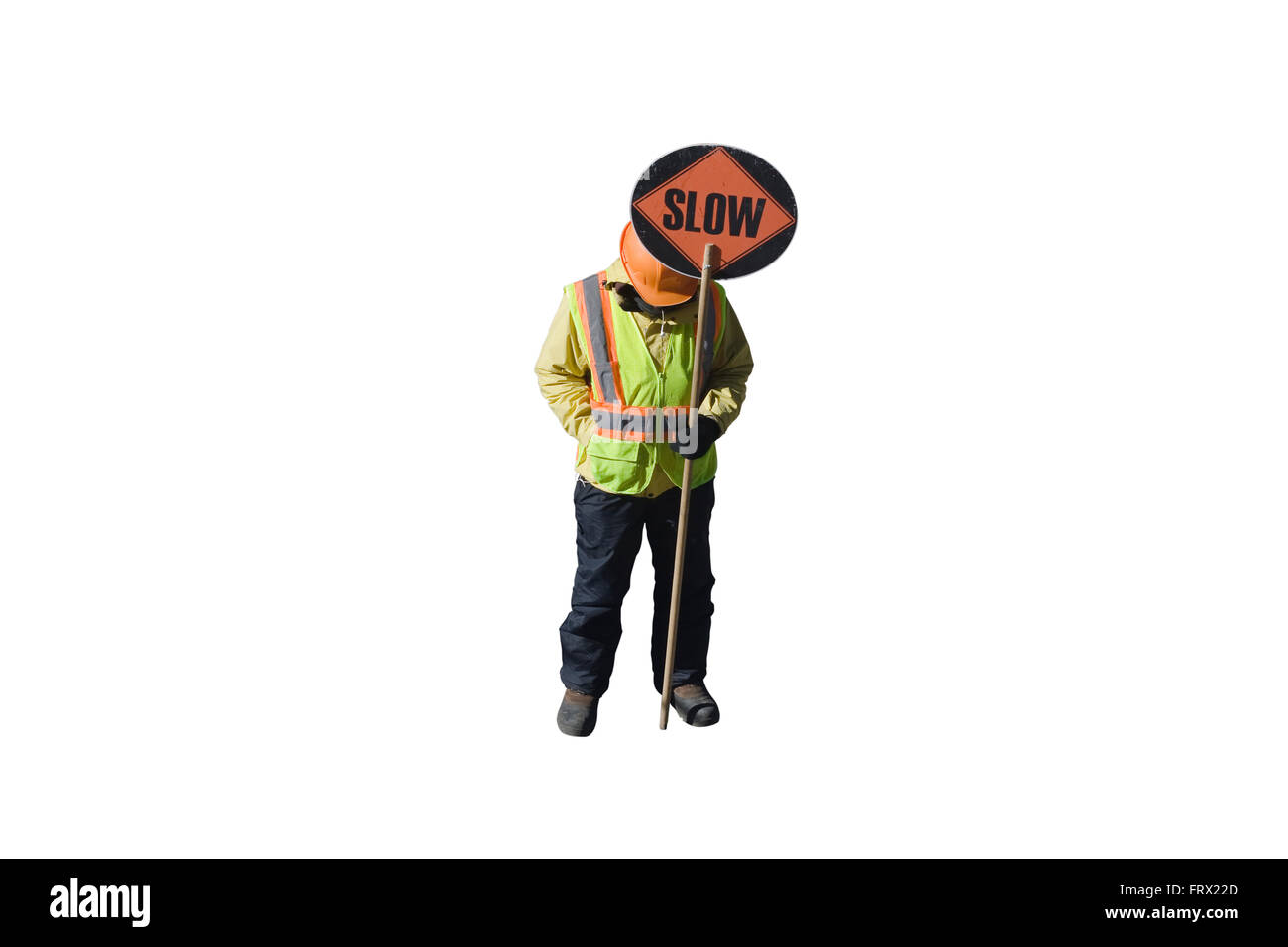 Cut Out. Construction Worker with a hardhat and an orange reflective vest holds a round sign on a pole with SLOW printed on it Stock Photo