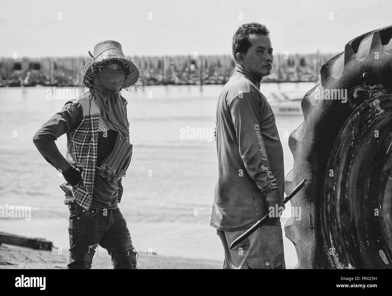 Local boat yard workers around the pier. Stock Photo