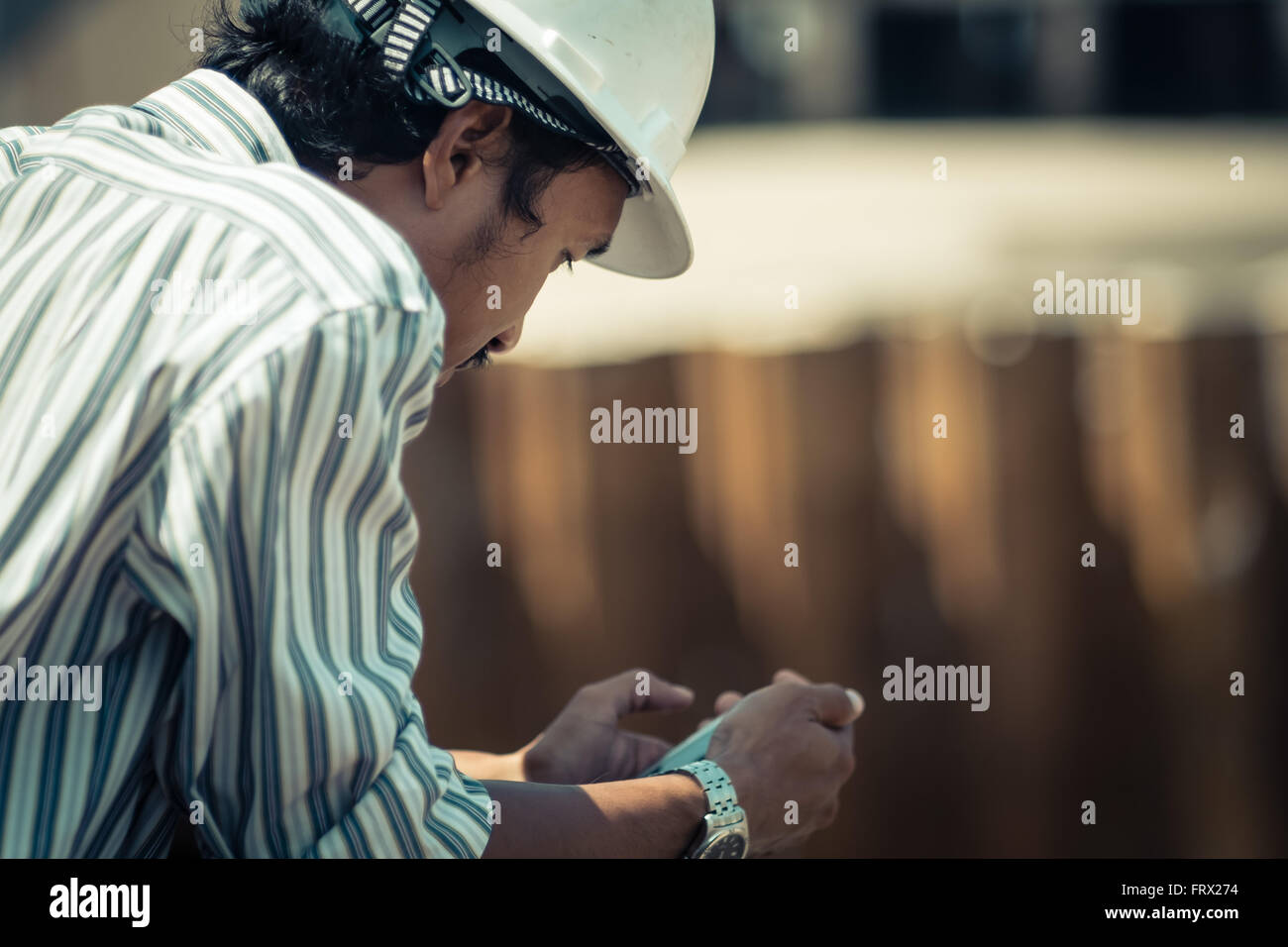 Manager of construction checking his phone. Stock Photo