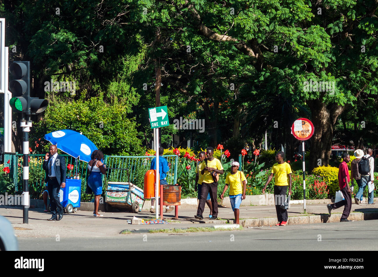 Pedestrians passing Africa Unity Square, CBD, Harare, Zimbabwe Stock Photo