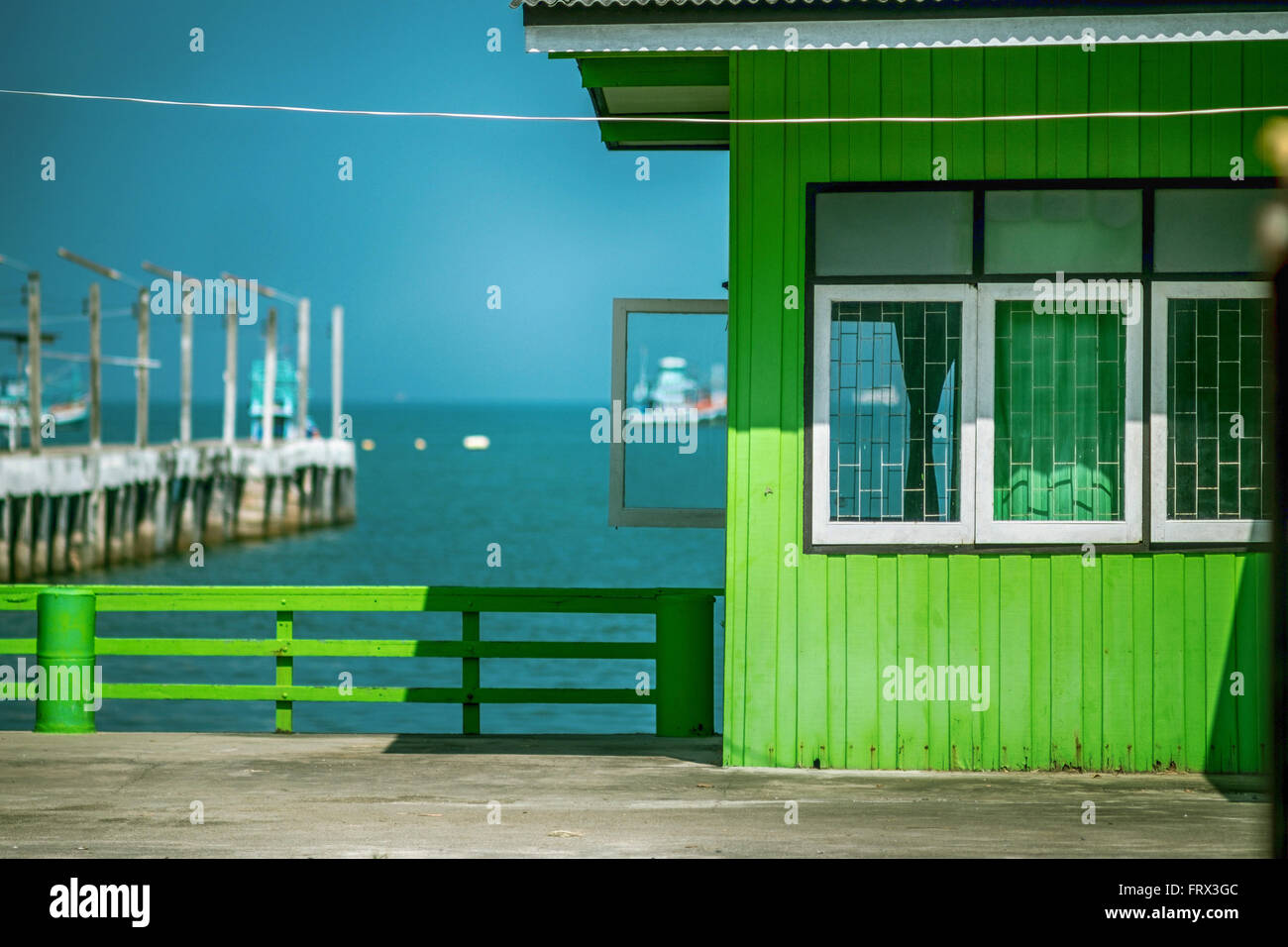 Vibrant green house in a local fishing village Thailand. Stock Photo
