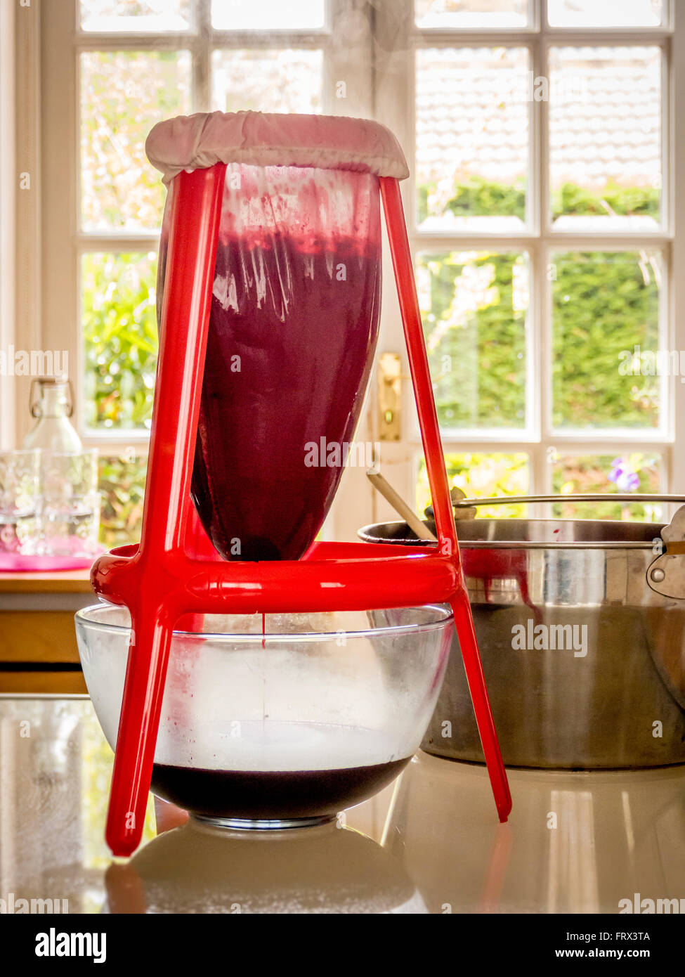 straining fruit that is softened by cooking, through a muslin bag