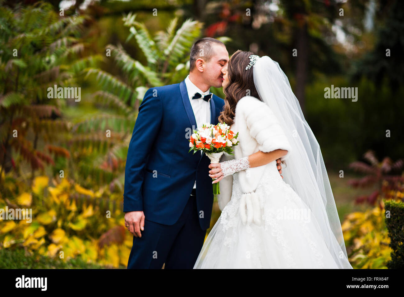Happy wedding couple in love at autumn park Stock Photo - Alamy