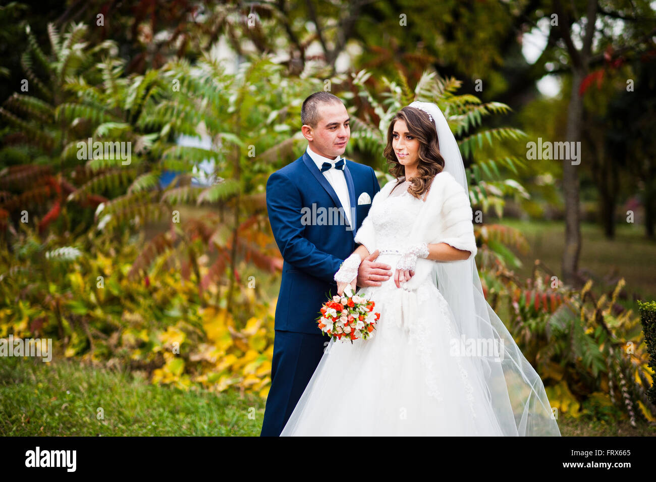 Happy wedding couple in love at autumn park Stock Photo - Alamy