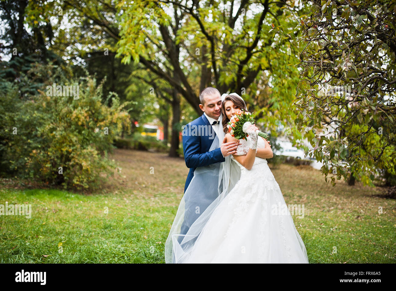 Happy wedding couple in love at autumn park Stock Photo - Alamy