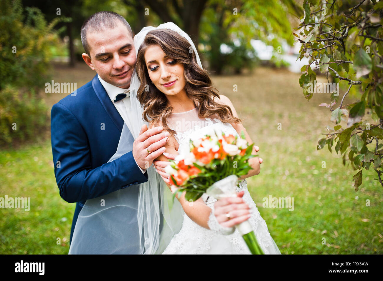 Happy wedding couple in love at autumn park Stock Photo - Alamy