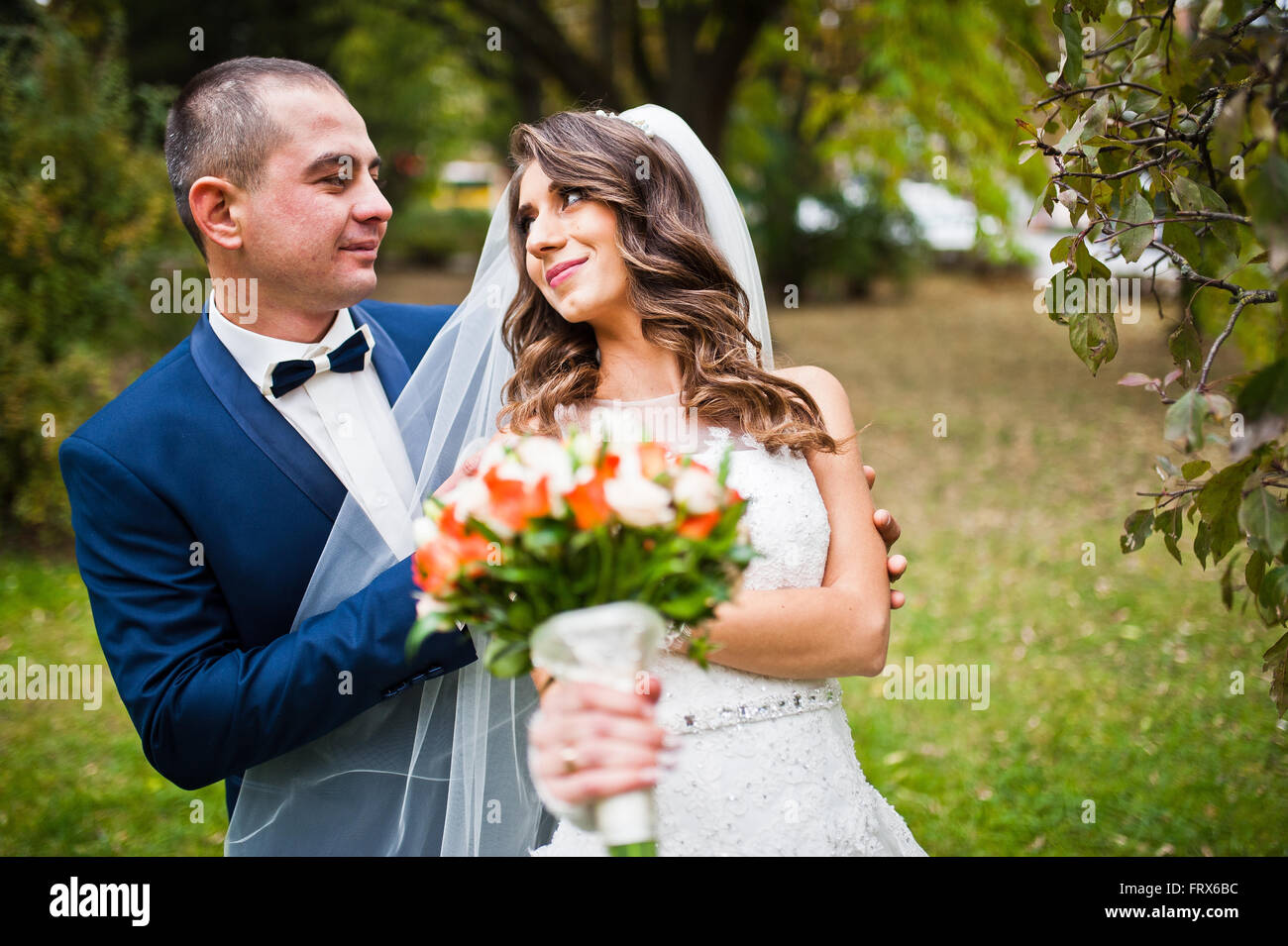 Happy wedding couple in love at autumn park Stock Photo - Alamy