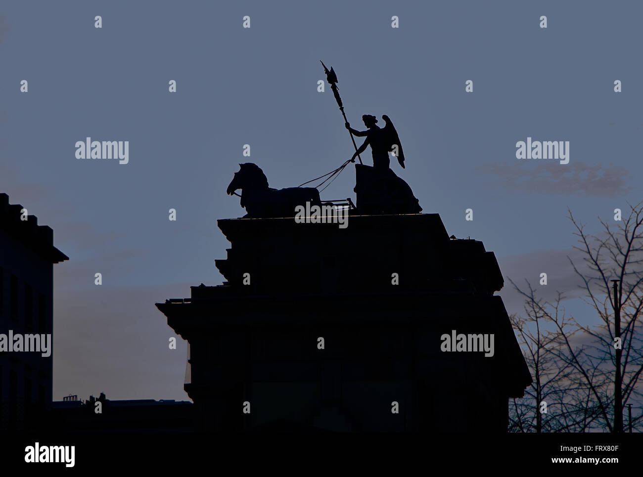 The quadriga located atop the Brandenburg Gate in Berlin, Germany,  was designed by Johann Gottfried Schadow in 1793 as the Quad Stock Photo