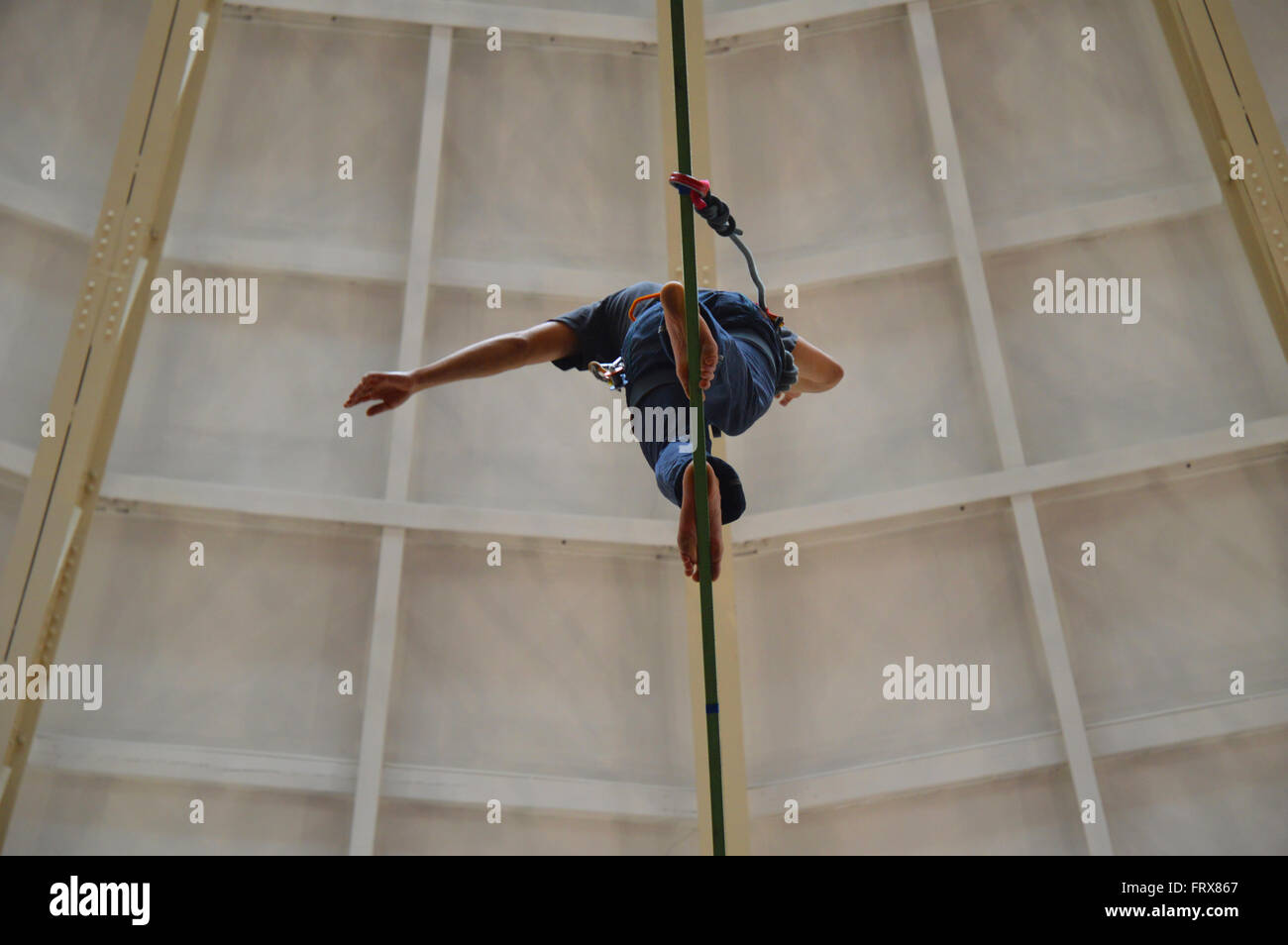 Tightrope walker at the top of the Devonshire Dome in Buxton, Derbyshire. Stock Photo