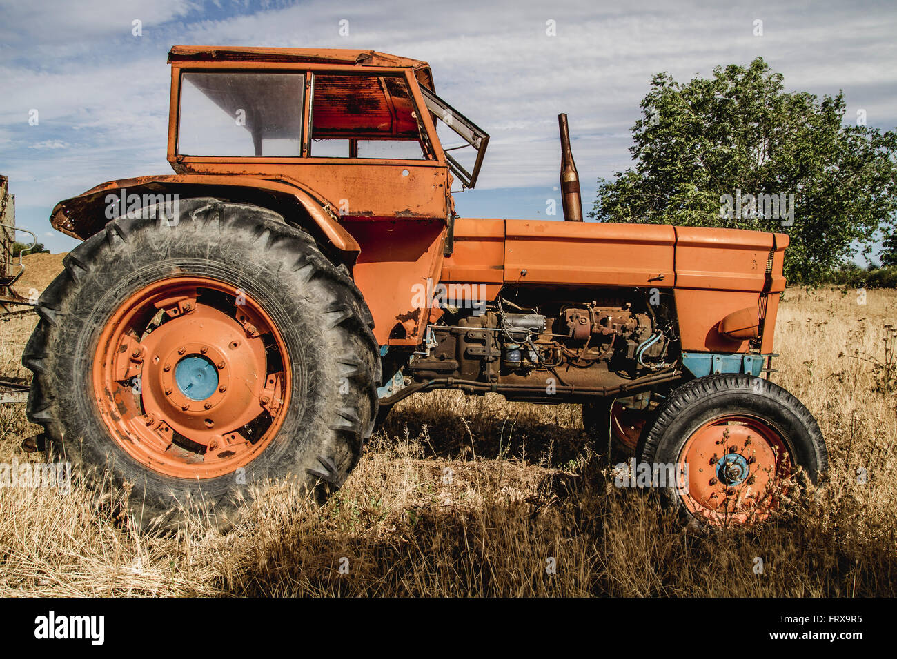 old agricultural tractor abandoned in a farm field Stock Photo - Alamy